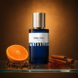Stellar Hour perfume bottle with halved mandarin, black peppercorns, saffron threads and cinnamon sticks, amber spiced dupe by Aromara