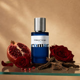 Crimson Voyage by Aromara, 35% extrait perfume bottle on a glass shelf with pomegranate, red roses and oud wood accents
