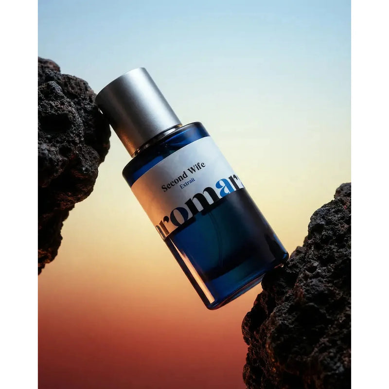 Blue bottle labeled 'Second Wife' with 'aromara' on a gradient background