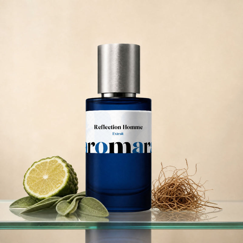 Reflection Homme by Aromara, 35% extrait perfume bottle on a glass shelf with halved bergamot, sage leaves and vetiver root accents