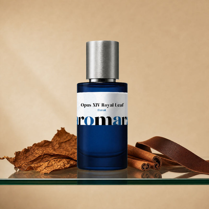 Opus XIV Royal Leaf by Aromara, 35% extrait perfume bottle on a glass shelf with tobacco leaves, cinnamon sticks and leather accents