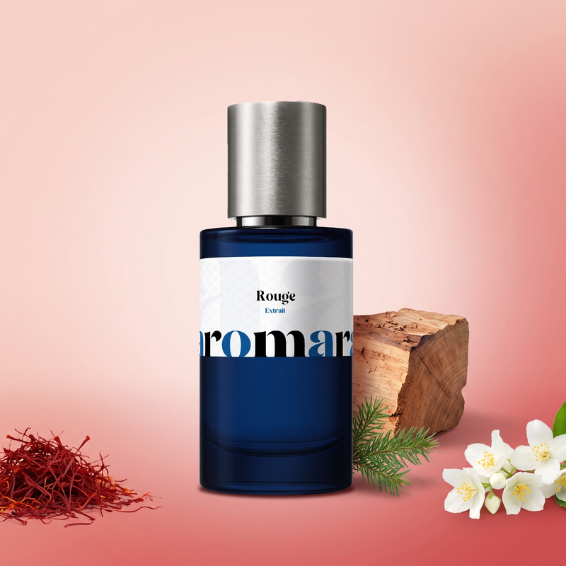 Rouge by Aromara on a blush pink and rosy red background with saffron threads, jasmine flowers, cedarwood and a fir sprig. 35% Extrait, inspired by Maison Francis Kurkdjian Baccarat Rouge 540.