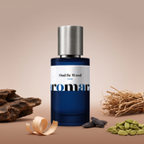 Oud De Wood by Aromara on a warm taupe and sandalwood brown background with oud wood, cardamom pods, vetiver roots, tonka beans and sandalwood shavings. 35% Extrait, inspired by Tom Ford Oud Wood.