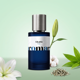 Lilyphia by Aromara on a pale mint to soft sage green background with a white lily, a lily bud, green leaves, white tea buds and cotton. 35% Extrait, inspired by Diptyque Lilyphea.