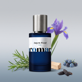 Amyris Wood by Aromara on a pale silver grey to soft juniper blue-grey background with rosemary, juniper berries, an iris flower, pale wood and tonka beans. 35% Extrait, inspired by Maison Francis Kurkdjian Amyris Homme.
