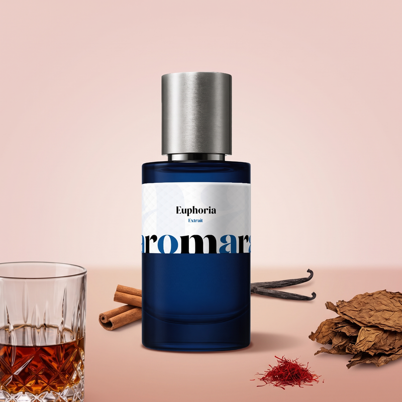 Euphoria by Aromara on a pale blush rose and soft cinnamon rose background with a glass of rum, tobacco leaves, cinnamon sticks, vanilla pods and saffron. 35% Extrait, inspired by Initio Side Effect.