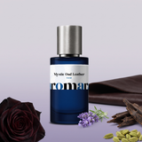 Mystic Oud Leather by Aromara on a pale heather grey to soft smoky violet background with a black rose, oud wood chips, leather, lavender and cardamom pods. 35% Extrait, inspired by Penhaligon's Halfeti Leather.