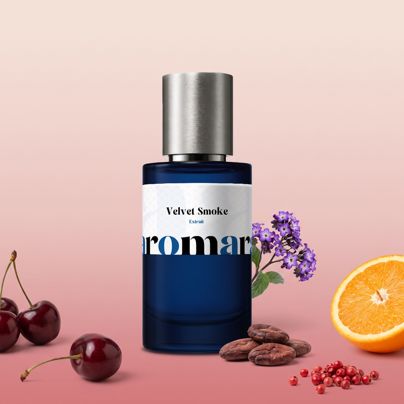 Velvet Smoke by Aromara on a pale blush to soft cherry rose background with cherries, a halved orange, heliotrope, cacao beans and pink peppercorns. 35% Extrait, inspired by BDK Parfums Rouge Smoking.