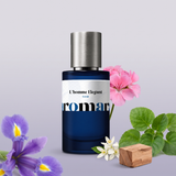 L'homme Elegant by Aromara on a pale powder grey to soft iris lilac background with an iris, violet leaves, a pink geranium, neroli blossoms and cedarwood. 35% Extrait, inspired by Prada L'Homme.