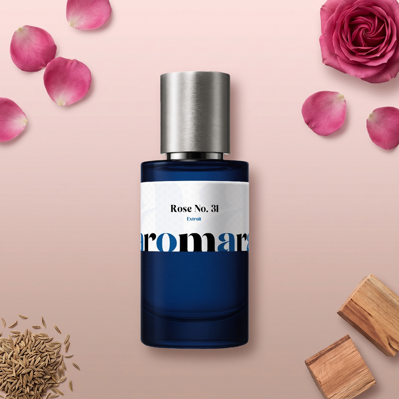 Rose No. 31 by Aromara on a pale blush pink to cedar taupe background with a pink rose, rose petals, cumin seeds and cedar wood. 35% Extrait, inspired by Le Labo Rose 31.