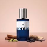 RUH by Aromara on a pale dusty peach to soft cinnamon rose background with cinnamon sticks, cardamom pods, nutmeg, tonka beans, vanilla pods and sandalwood. 35% Extrait, an Aromara original.