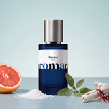 Tideline by Aromara on a pale sea mist blue to sage blue-grey background with grapefruit, sea salt, sage, driftwood and red algae. 35% Extrait, inspired by Jo Malone Wood Sage & Sea Salt.