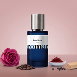 Rose Brew by Aromara on a pale dusty rose to mocha rose background with a damask rose, coffee beans, saffron threads, black peppercorns and sandalwood. 35% Extrait, inspired by Tom Ford Cafe Rose.