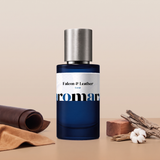 Falcon & Leather by Aromara on a pale stone beige to saddle tan background with dark leather, tan suede, cedarwood, dry wood bark and a cotton flower. 35% Extrait, inspired by Matière Première Falcon Leather.