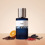 Lucius by Aromara on a pale latte cream to bitter-orange terracotta background with coffee beans, a bitter orange, pink peppercorns, vanilla pods and tonka beans. 35% Extrait, inspired by Fragrance Du Bois Lucius Maximus.