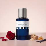 Sandalwood Major by Aromara on a pale rose cream to sandalwood rose-beige background with a red rose, sandalwood, amber resin and vanilla pods. 35% Extrait, inspired by Serge Lutens Santal Majuscule.