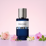 Flower Bomber by Aromara on a pale peony pink to soft orchid pink background with a pink rose, freesia, jasmine and orange blossoms, a pink orchid and patchouli leaves. 35% Extrait, inspired by Viktor & Rolf Flowerbomb.