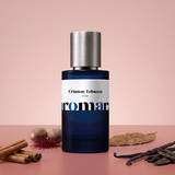 Crimson Tobacco by Aromara on a pale cinnamon rose to soft crimson clay background with cinnamon sticks, nutmegs, saffron threads, a tobacco leaf, vanilla pods and oud chips. 35% Extrait, inspired by Mancera Red Tobacco.