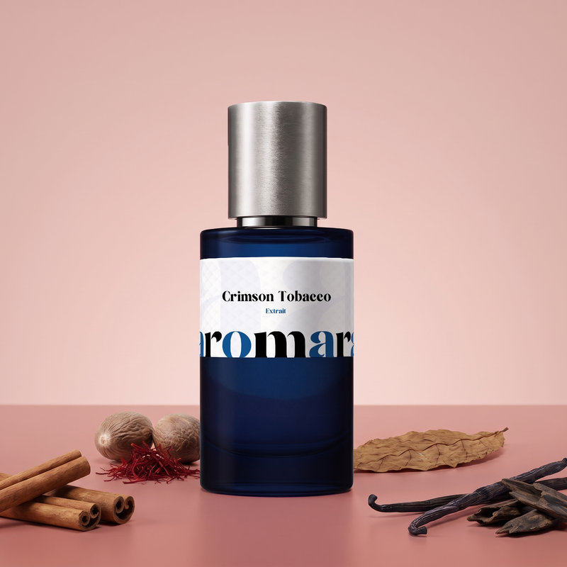 Crimson Tobacco by Aromara on a pale cinnamon rose to soft crimson clay background with cinnamon sticks, nutmegs, saffron threads, a tobacco leaf, vanilla pods and oud chips. 35% Extrait, inspired by Mancera Red Tobacco.