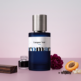 Lacquer Noir by Aromara on a pale pearl grey to soft dusky peony rose background with ebony wood, an inkwell, a burgundy peony, a halved apricot, black peppercorns and frankincense. 35% Extrait, inspired by Tom Ford Black Lacquer.