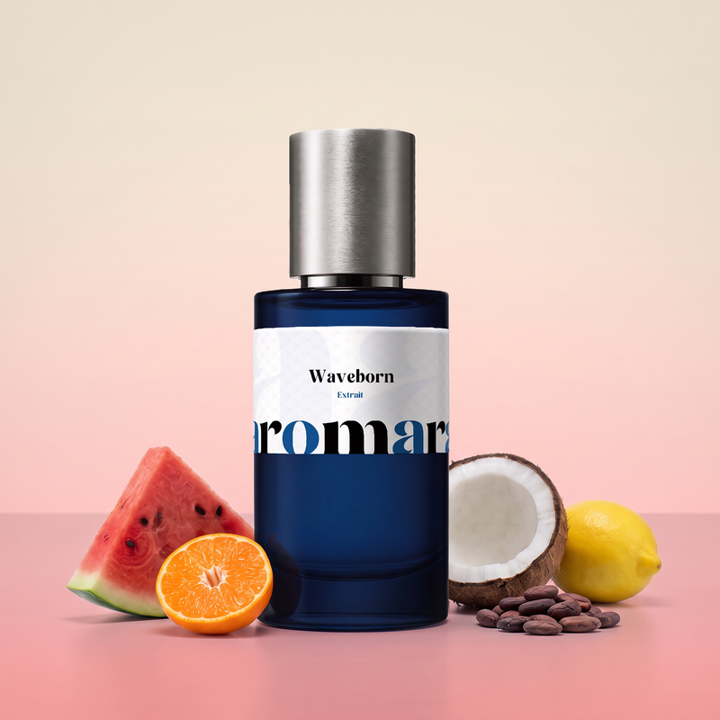 Waveborn by Aromara on a pale coconut cream to watermelon pink background with a watermelon slice, a halved mandarin, a halved coconut, a lemon and cocoa beans. 35% Extrait, inspired by Room 1015 Wavechild.