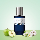 Eden Crisp Apple by Aromara on a pale mint cream to green apple background with green apples, jasmine, a white freesia and a cotton flower. 35% Extrait, inspired by Kayali Eden Juicy Apple.