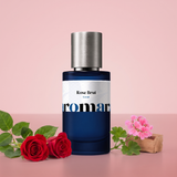 Rose Brut by Aromara on a pale rosewater pink to vintage rose background with red roses, rose leaves, pink geranium and a cedarwood block. 35% Extrait, inspired by Matière Première Radical Rose.
