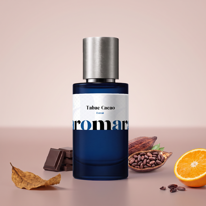Tabac Cacao by Aromara on a pale cocoa to dusty mocha rose background with a dried tobacco leaf, dark chocolate squares, an open cacao pod and orange. Up to 35% Extrait, inspired by Tom Ford Tobacco Chocolat.